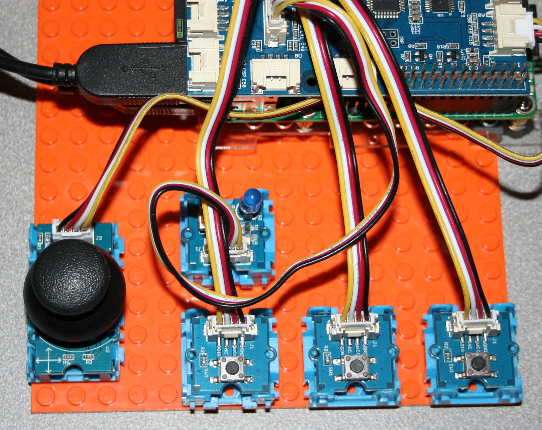 Several Grove modules are mounted to a LEGO baseplate.